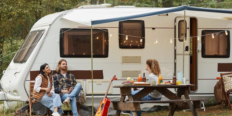 friends relaxing outside by rv